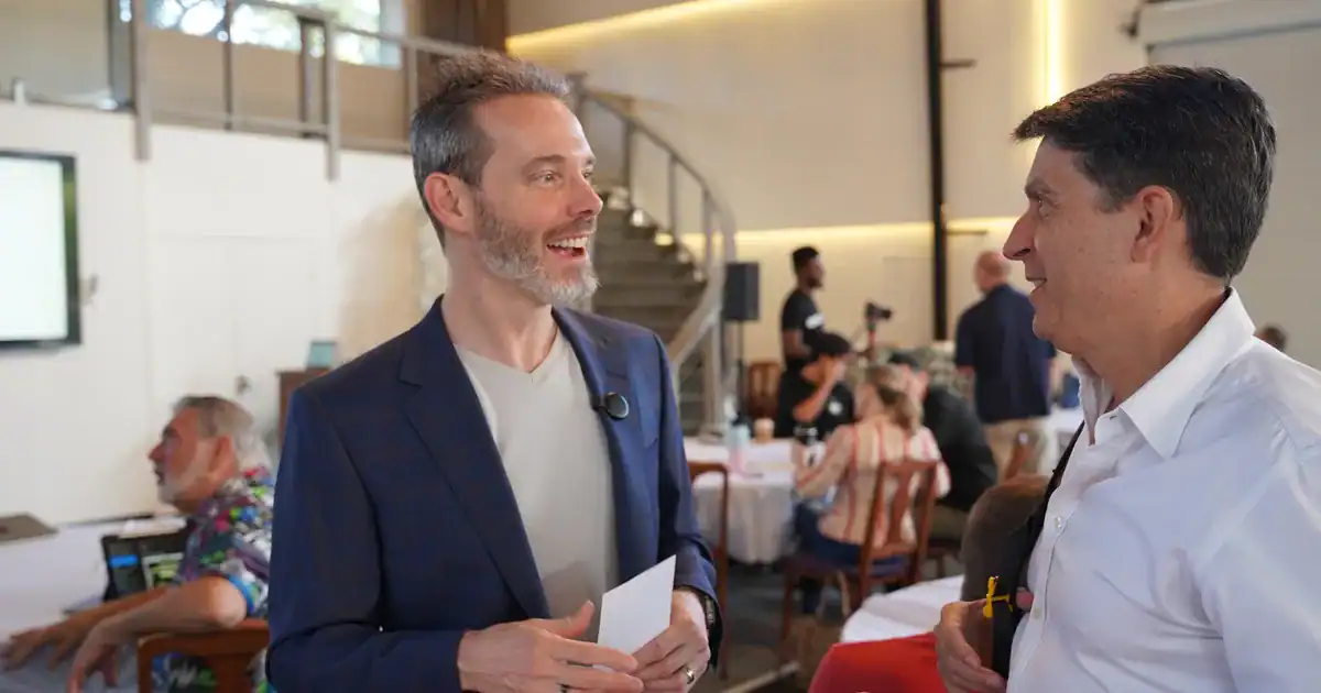 Charles Byrd in conversation with an entrepreneur at a Flow Mastermind event