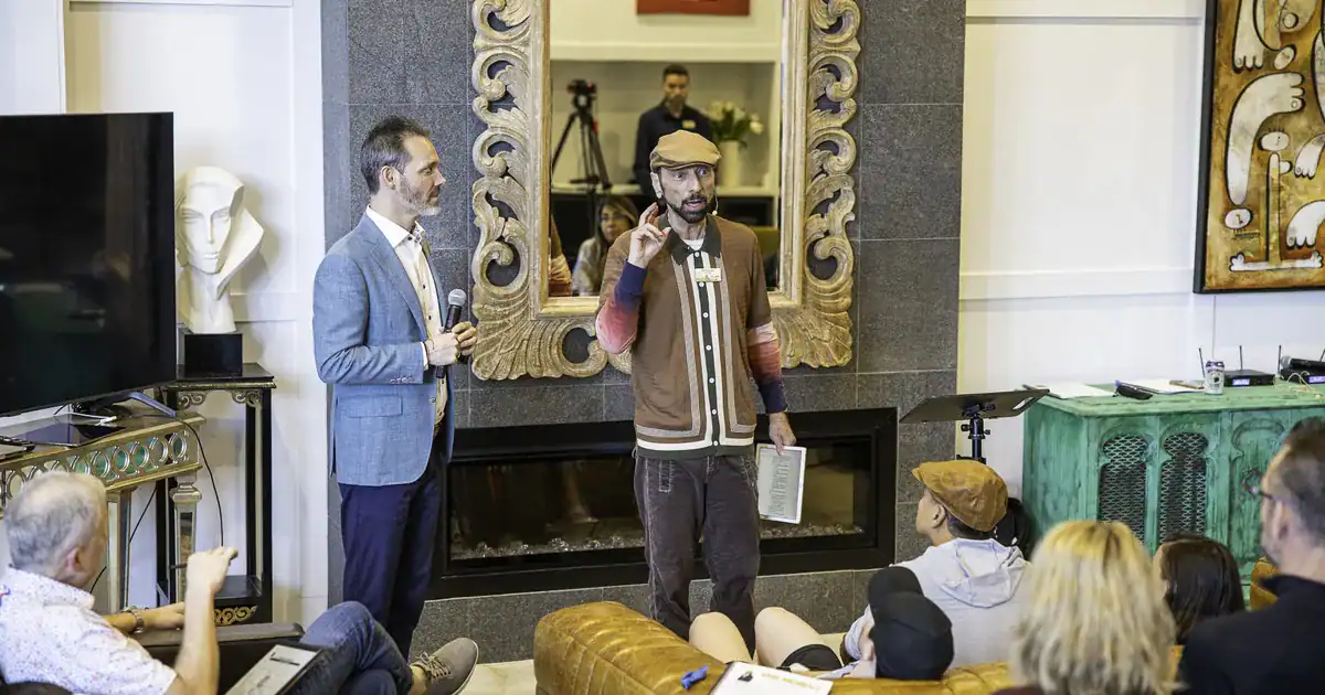 Charles Byrd on stage with a co-host at a Flow Mastermind event