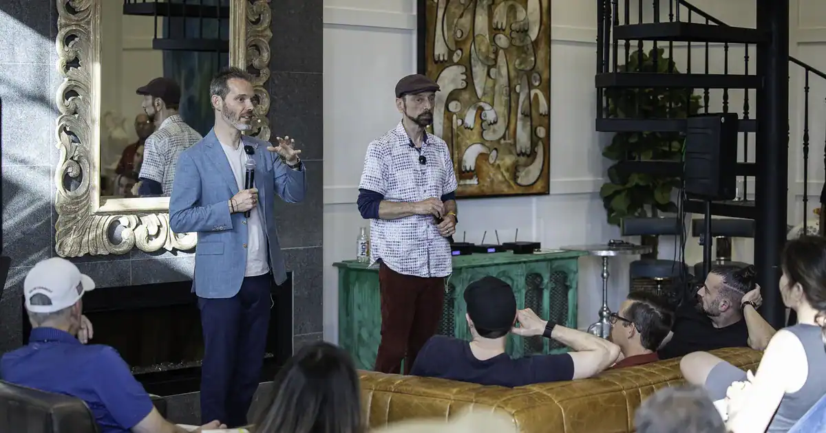 Charles Byrd and a co-host speaking to a room of entrepreneurs